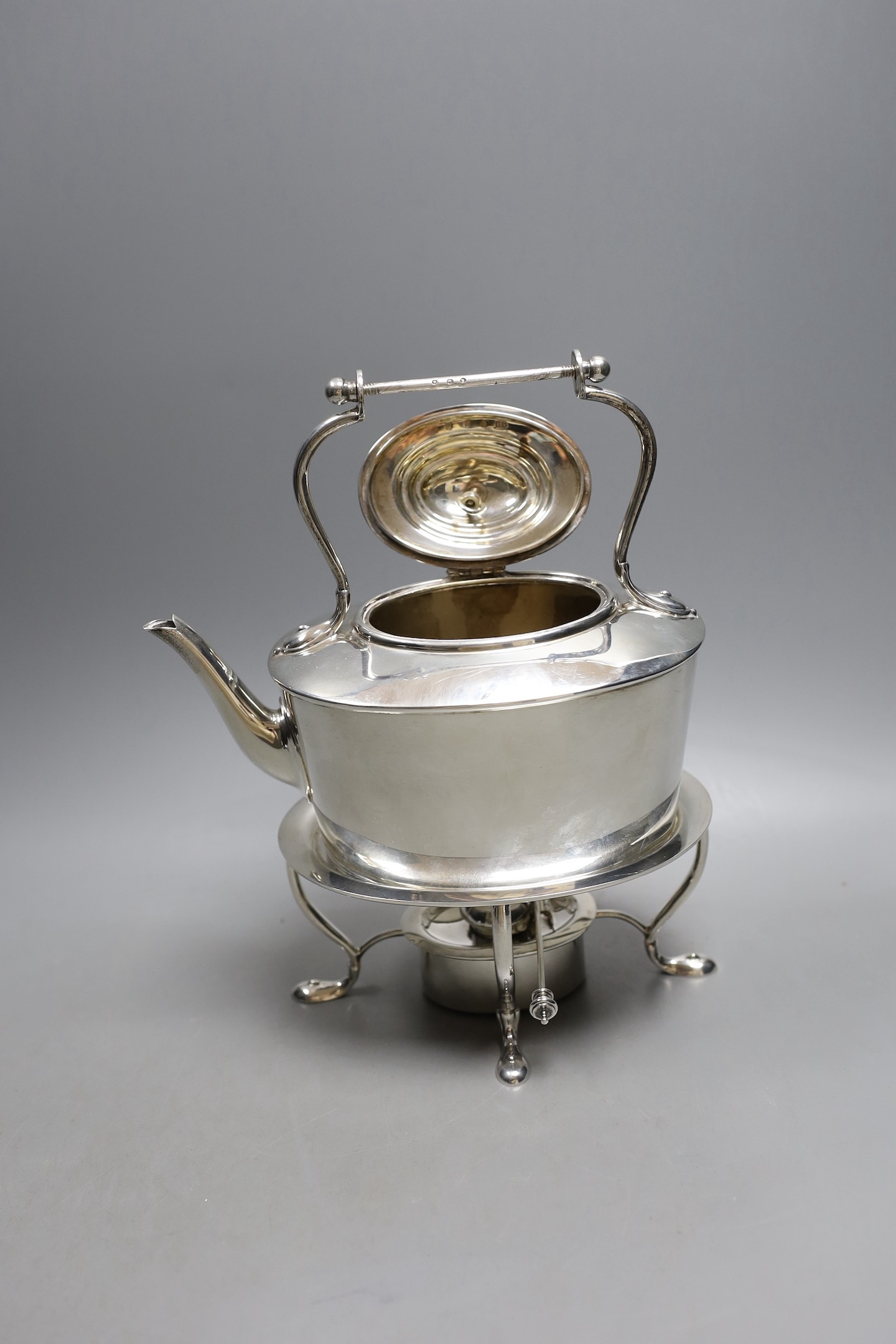 An Edwardian Scottish silver oval tea kettle, on stand with burner, Hamilton & Inches, Edinburgh, 1904, height 25.3, (handle missing), 27.5oz.
